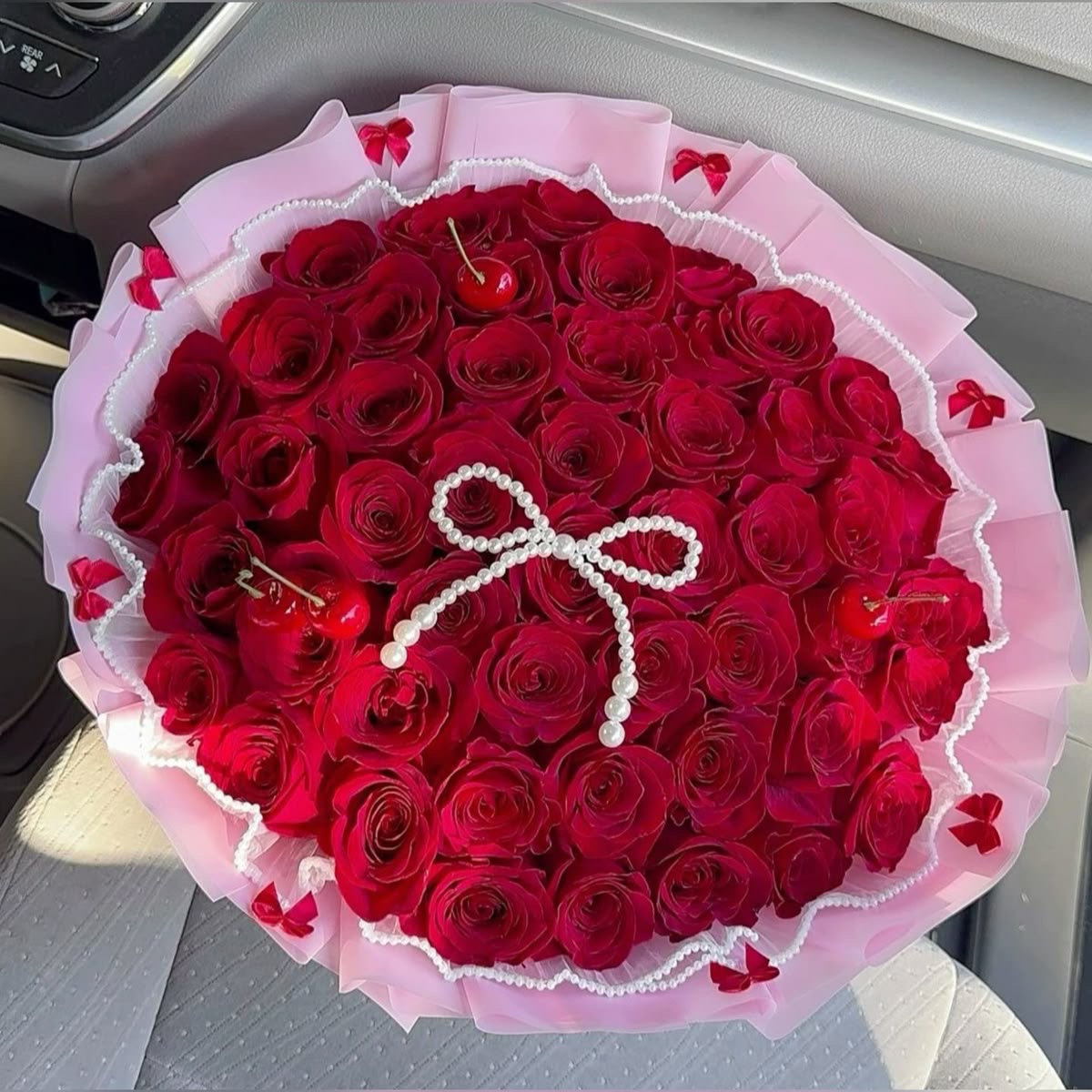 Hand-wrapped bouquet of one dozen red roses