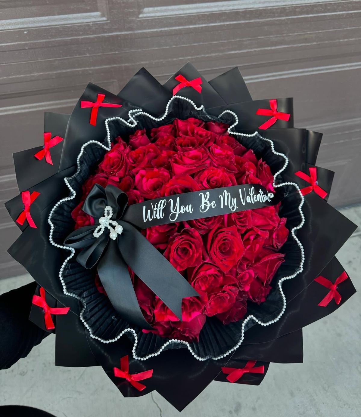Hand-wrapped bouquet of seventy-five red roses